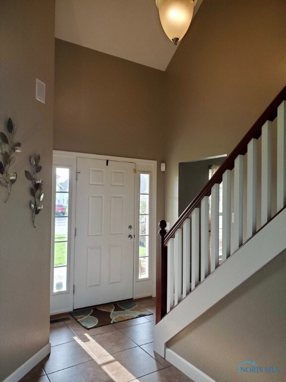 Tile entry with vaulted ceiling.
