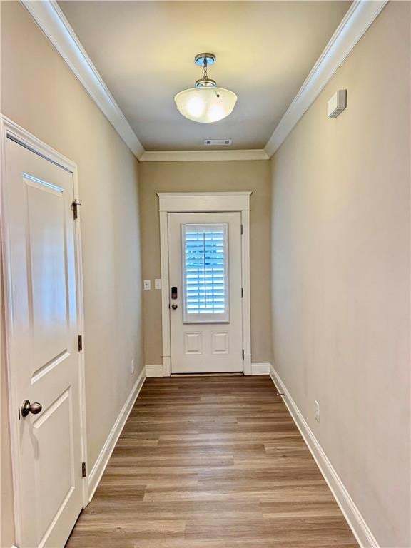 Doorway featuring baseboards, visible vents, light