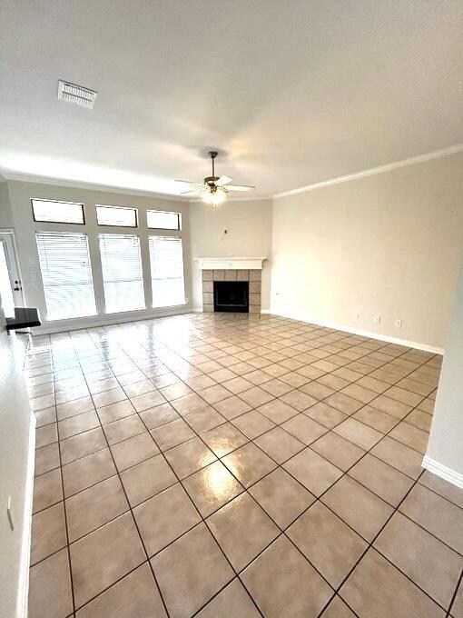 Unfurnished living room with crown molding, ceilin