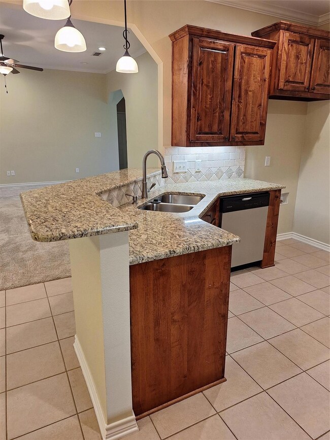 Kitchen featuring ceiling fan, kitchen peninsula, 