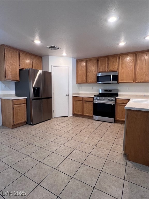 Kitchen featuring stove, refrigerator, light count