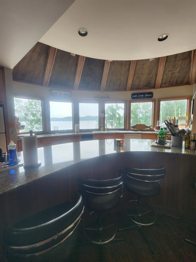 Bar area with healthy amount of natural light, recessed lighting, and a sink