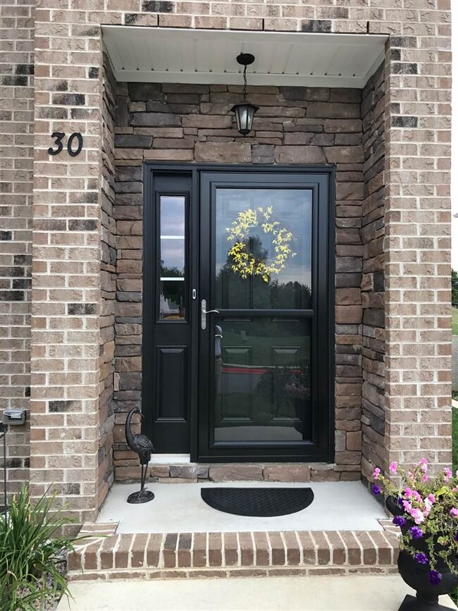 FRONT PORCHES ARE ALTERED FROM HAVING STONE VENEER