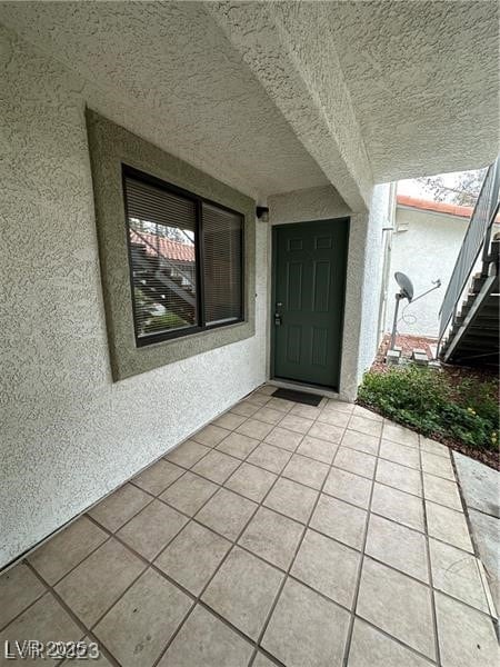 Property entrance with stucco siding