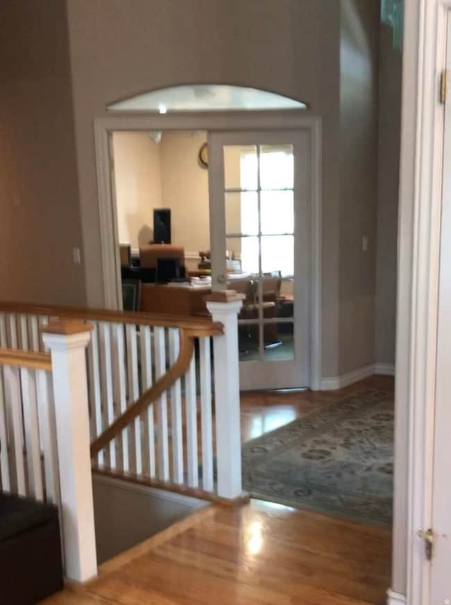 Stairway featuring wood finished floors and baseboards