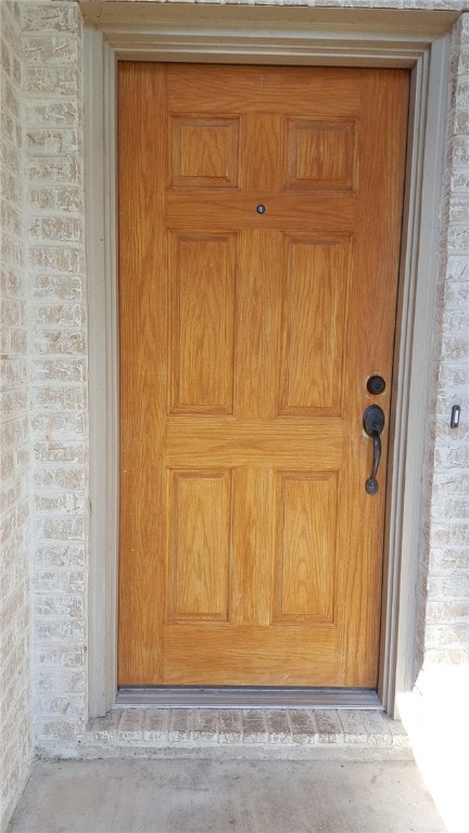 Property entrance featuring brick siding