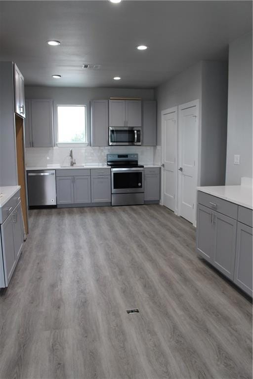 Kitchen with gray cabinets, stainless steel appli