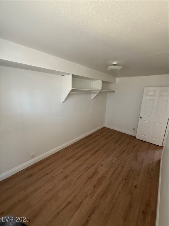 Spacious closet featuring wood finished floors