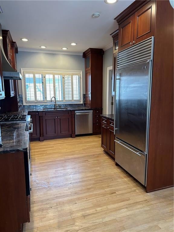 Kitchen with dark stone countertops, a sink, stain