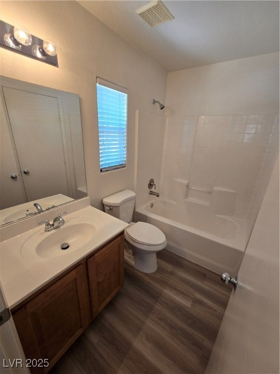 Bathroom with wood finished floors, vanity, and  shower combination
