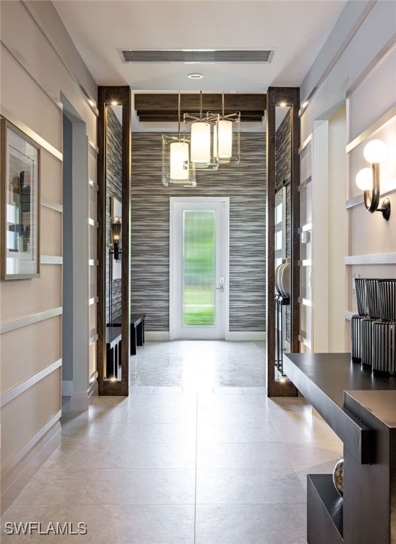Foyer featuring wallpapered walls, french doors, a