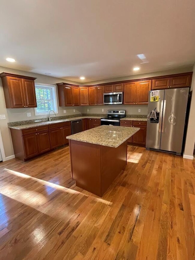 Hardwood flooring in picture is Plano Marsh Oak. Cabinets are Cognac Maple. Jefferson Kitchen will have the same cabinets and flooring.