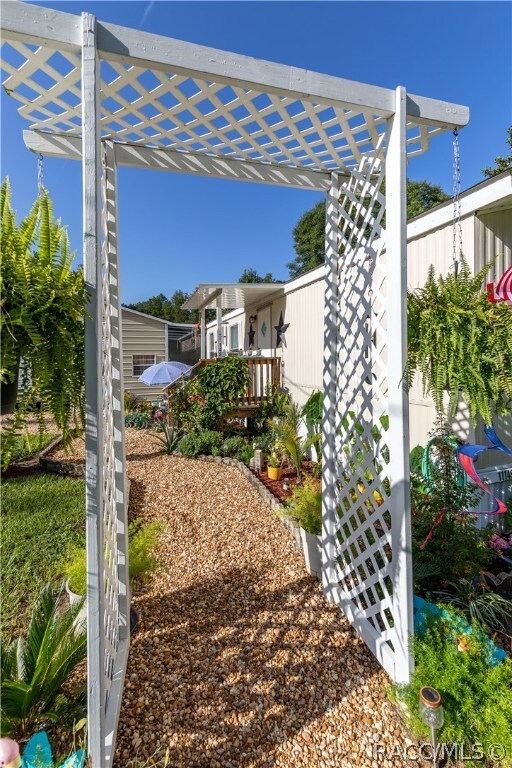 Custom entry way with detailed landscaping