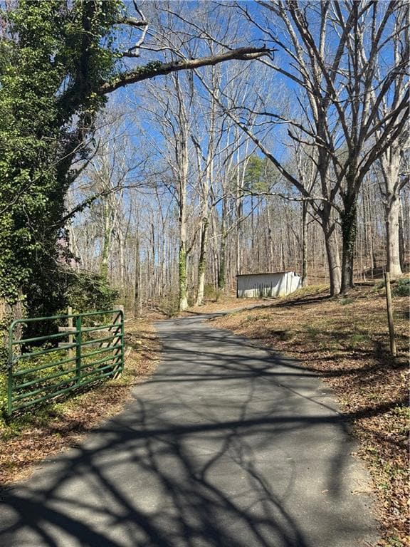 View of street featuring aphalt driveway and a vie