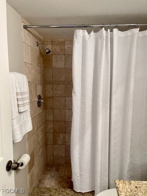 Bathroom with a tile shower and vanity