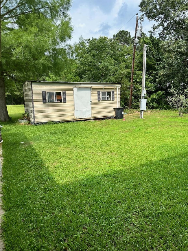 View of shed / structure with a yard