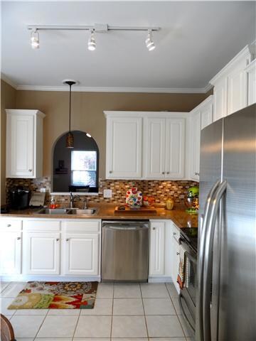 KITCHEN: Great size with breakfast area, stainless steel appiances, tile backsplash, upgraded lighting 