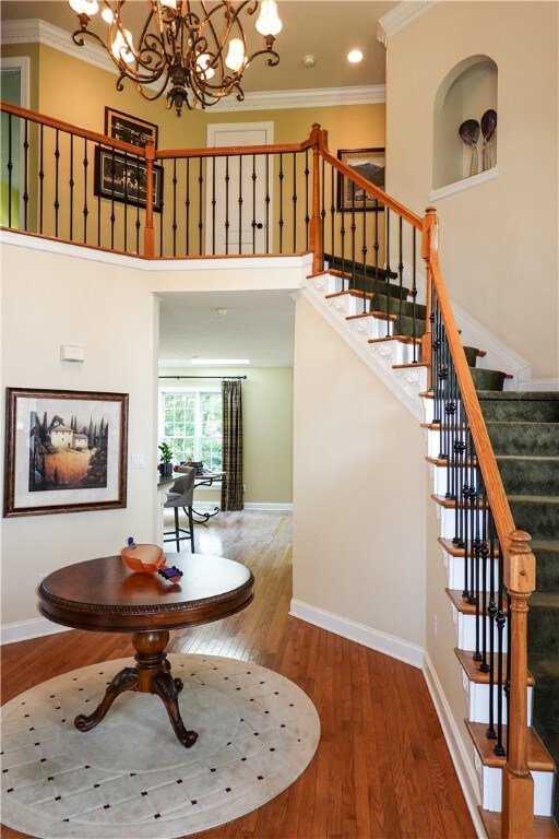 Grand 2 Story Entry with hardwood floor, crown mol