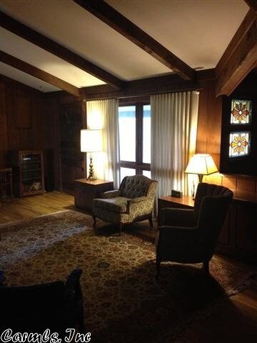 Den is open and has door leading to covered patio.