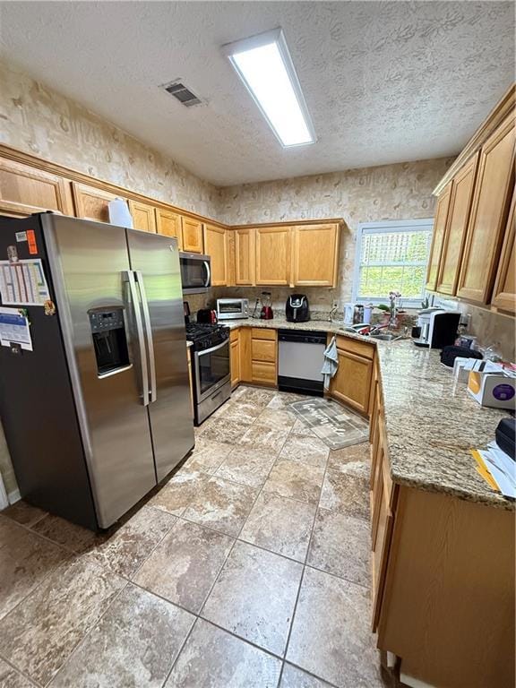 Kitchen featuring refrigerator, stove, dishwasher,