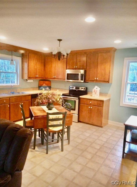 Kitchen featuring a chandelier, light tile floorin