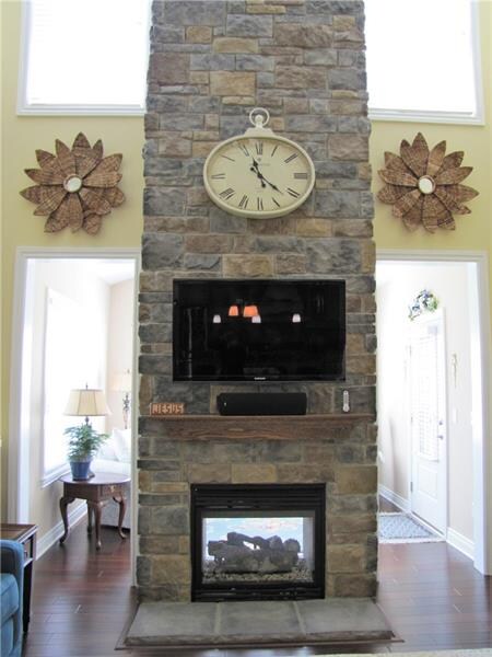 Two story double sided stone fireplace.