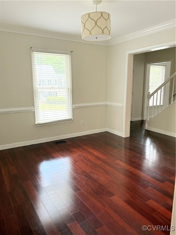 Empty room with crown molding, dark wood finished