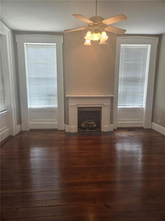 Unfurnished den featuring hardwood flooring, a bri