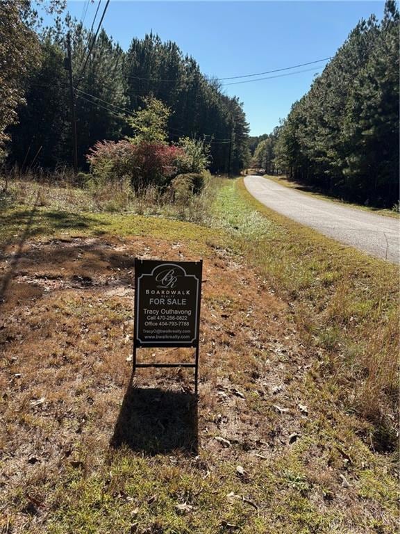 View of asphalt road with a view of trees