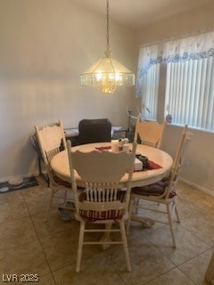 Dining area with tile patterned flooring and a cha