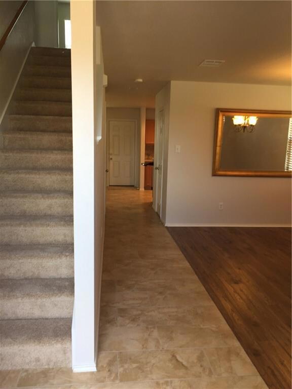 View from foyer with walkway to back door. Door to