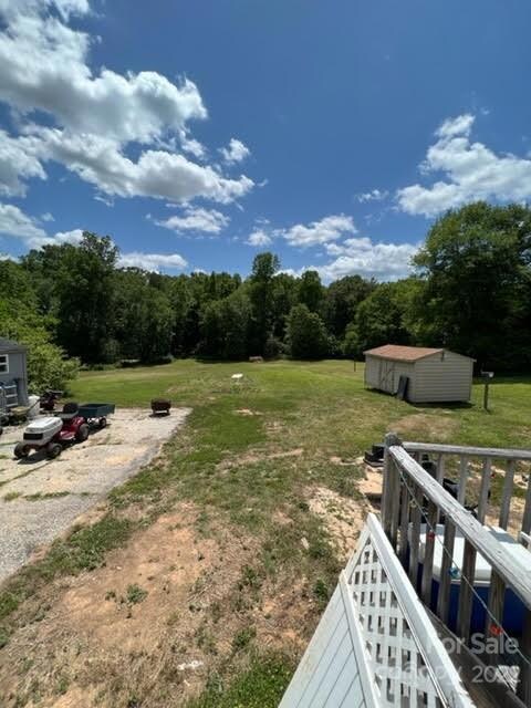 Back yard and outbuilding and paved parking pad