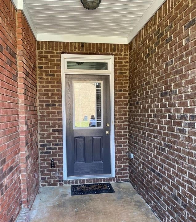Entrance to property with brick siding
