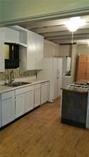 Kitchen featuring a sink, wood finished floors, a