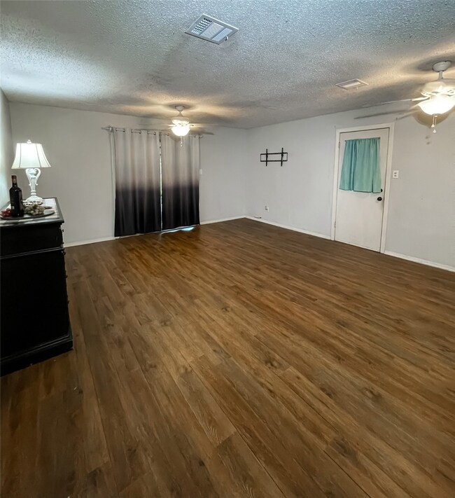 Spacious living room with sliding glass doors leading to the covered patio.