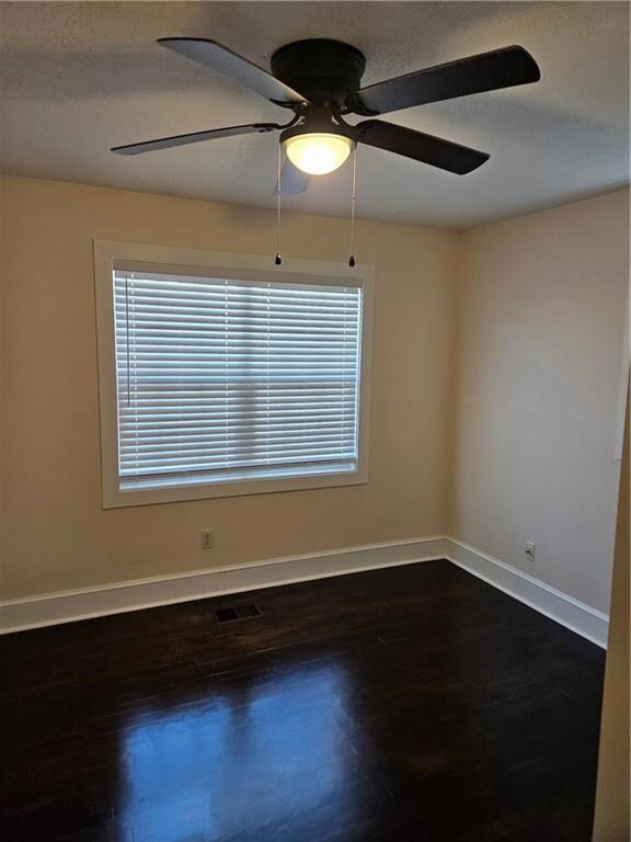 Spare room with baseboards, visible vents, ceiling