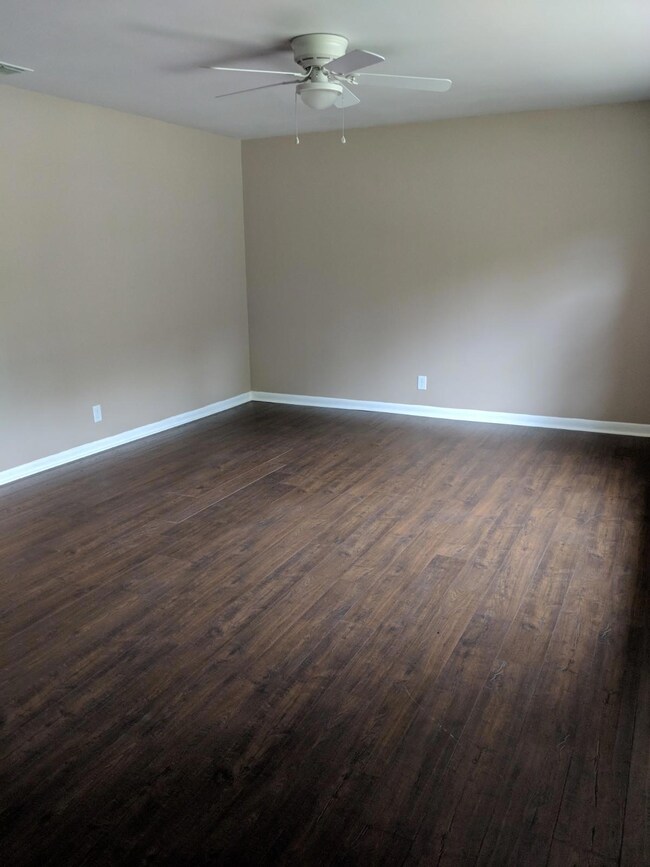 The living room is large with a lot of natural light.
