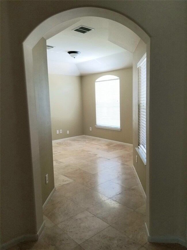 At the front of the house is a versatile room which could be a formal living room, an office, a den, or a bedroom!