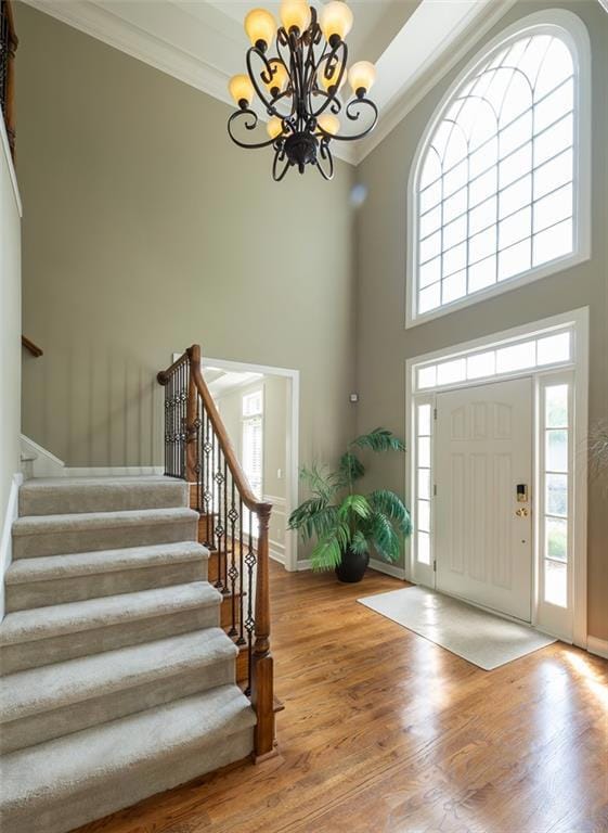 Entrance foyer with a chandelier, crown molding, s