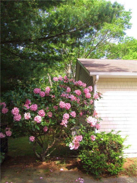 Mature plantings grace the acre lot and offer priv