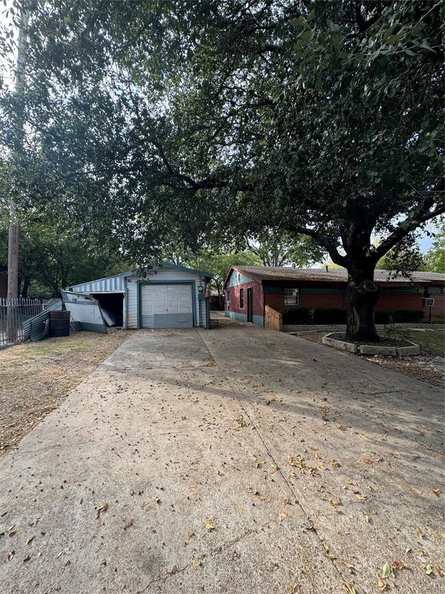 View of front of house featuring a storage unit an
