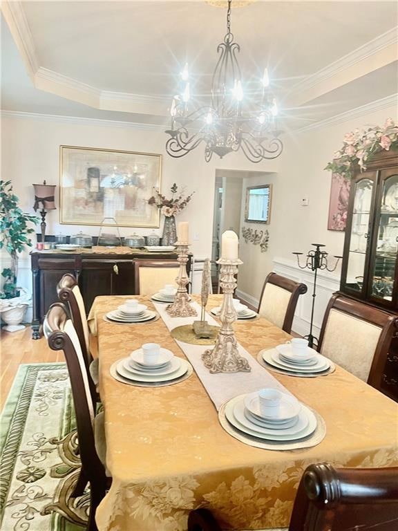 Dining space with a chandelier, wood finished floo