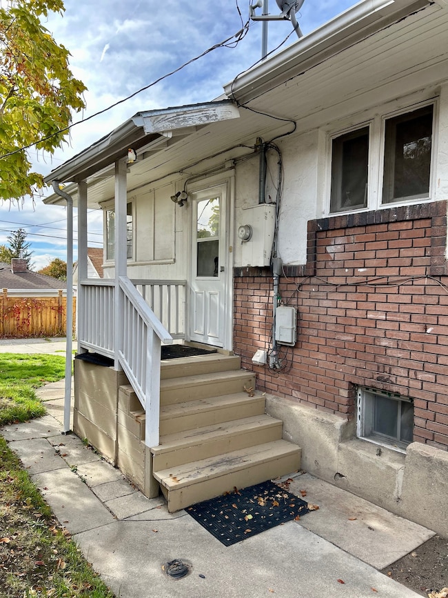 Side entrance to property with brick siding