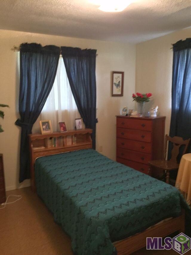 Cozy bedroom with two windows for natural lighting