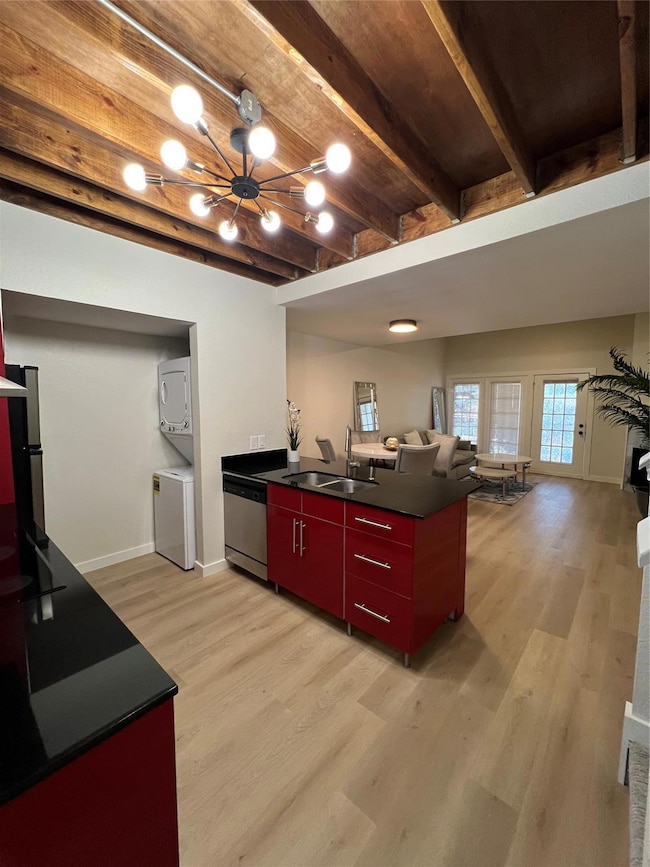 Kitchen featuring stacked washer and clothes dryer
