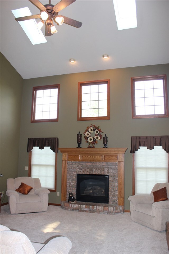 Spacious great room with fireplace, skylights, and