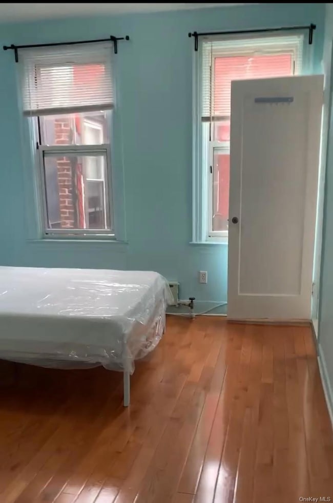 Bedroom with wood-type flooring