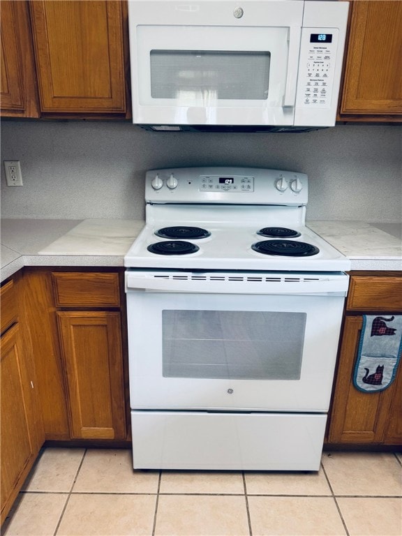 Kitchen featuring light tile patterned flooring, w
