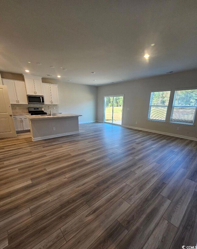 Interior space with dark hardwood / wood-style flo