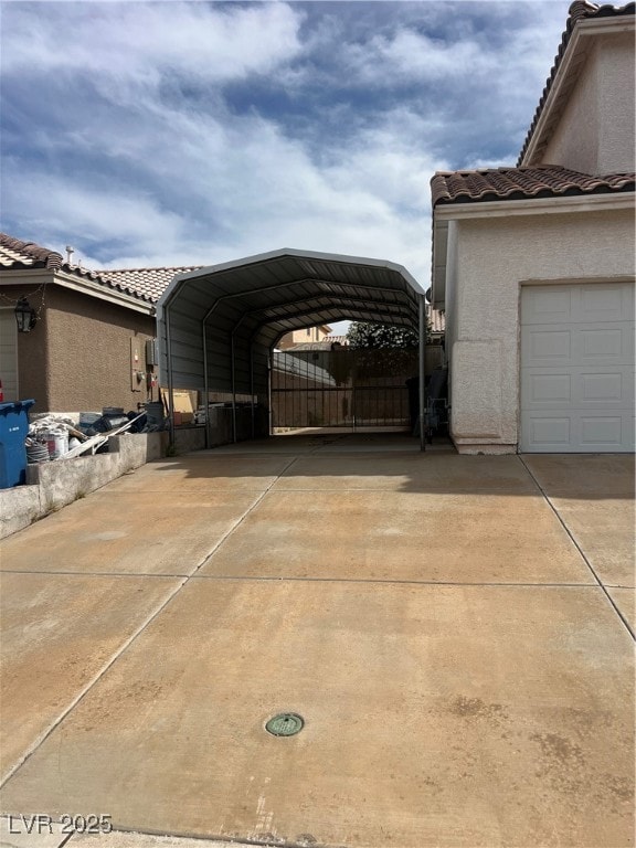 View of parking / parking lot featuring driveway,